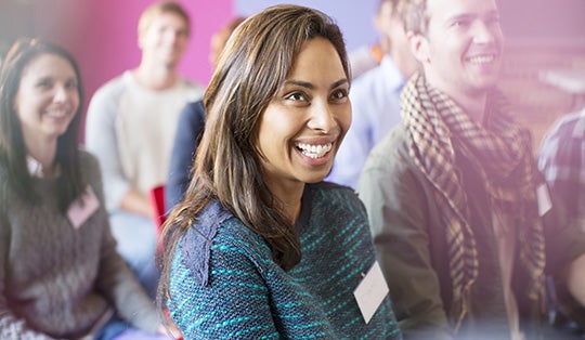 woman smiling in an audience