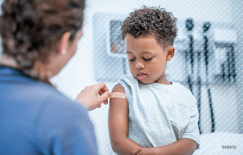 Little boy getting a bandaid after receiving a shot