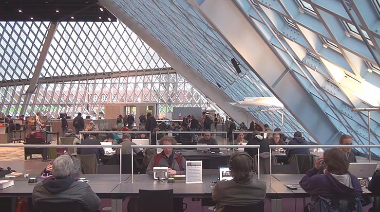 interior of library with people at desks and large windows