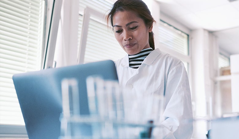 scientist working in laboratory on laptop