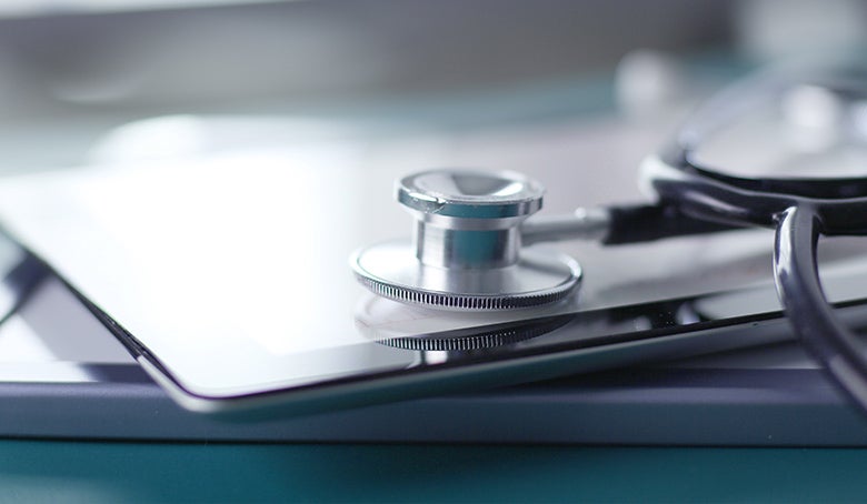 blue stethoscope and tablet on white background