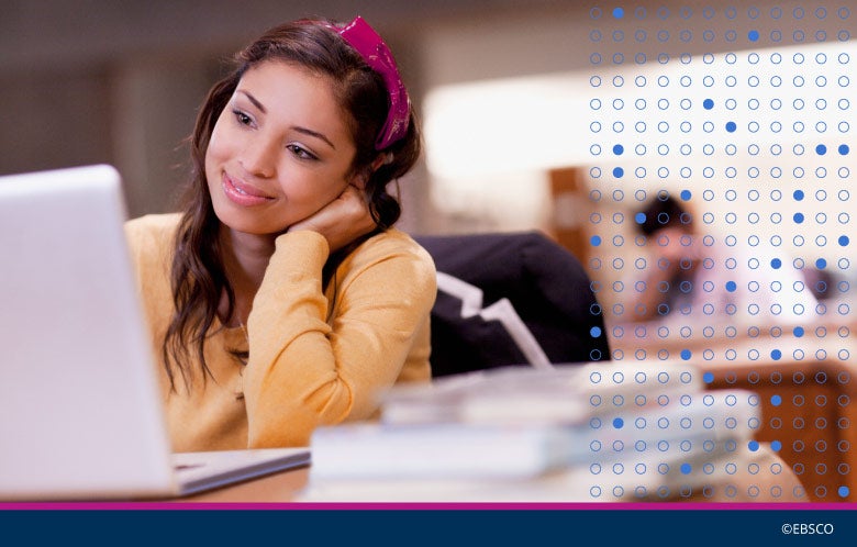 Female student thinking while using a laptop in the library