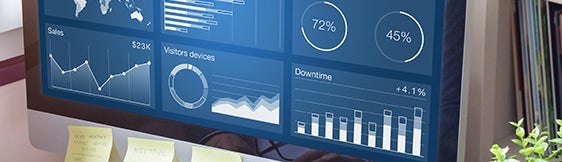 Desktop computer showing dashboard of usage analytics on screen