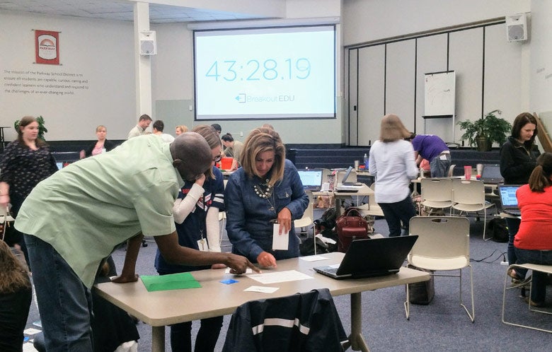 Teachers reviewing projects at a science fair