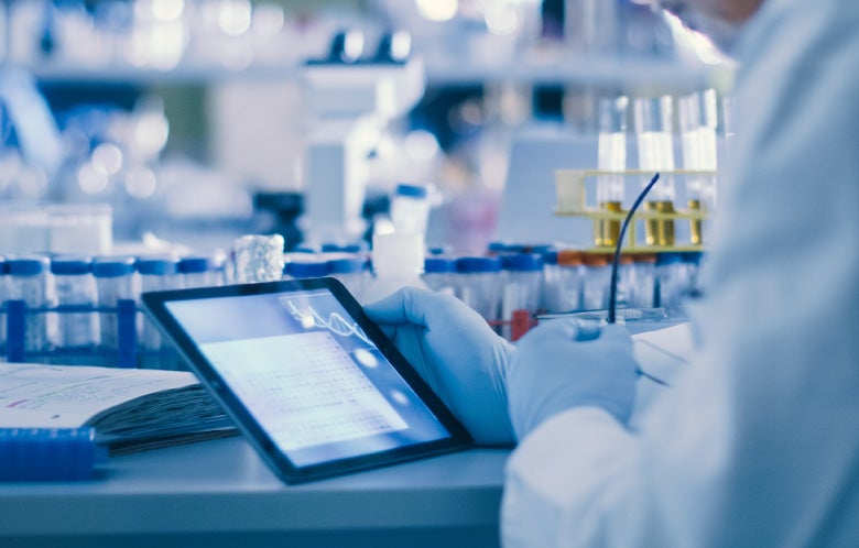 Close up of researcher looking at tablet in lab