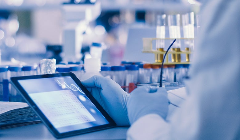 Research Scientist is Using a Tablet Computer in a Modern High-Tech Laboratory.