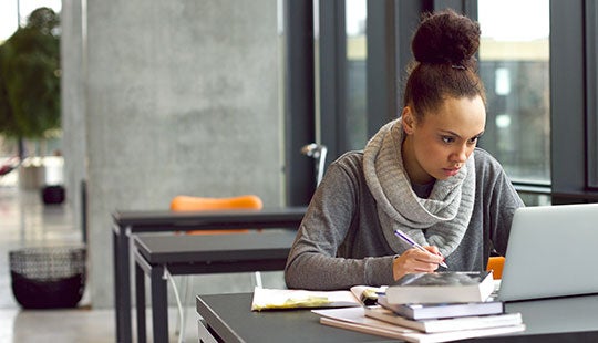 student researching at the library