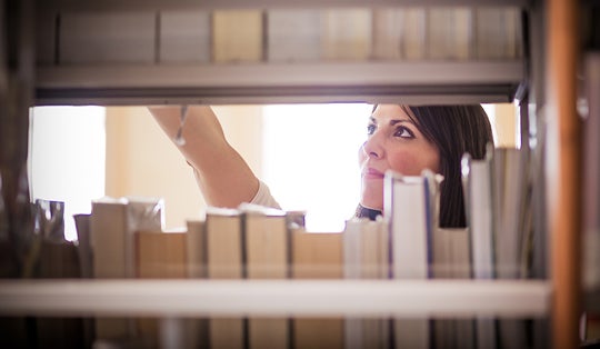 woman searching library stacks
