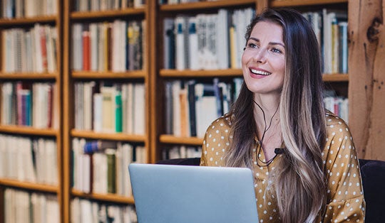 woman in the library at a laptop